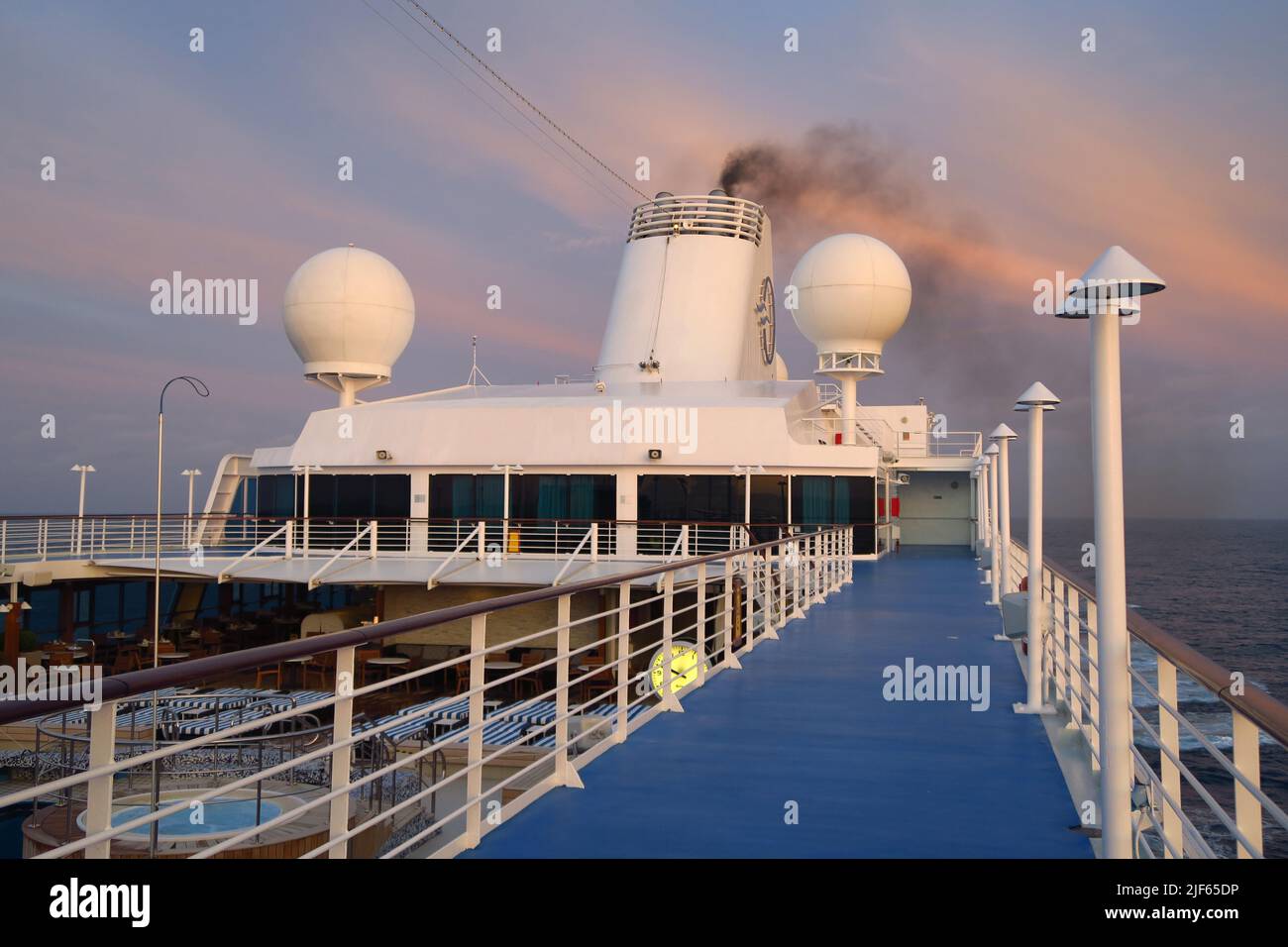 View of Oceania Cruises MS Sirena's top deck as it sails across the Bay of Biscay at sunset Stock Photo