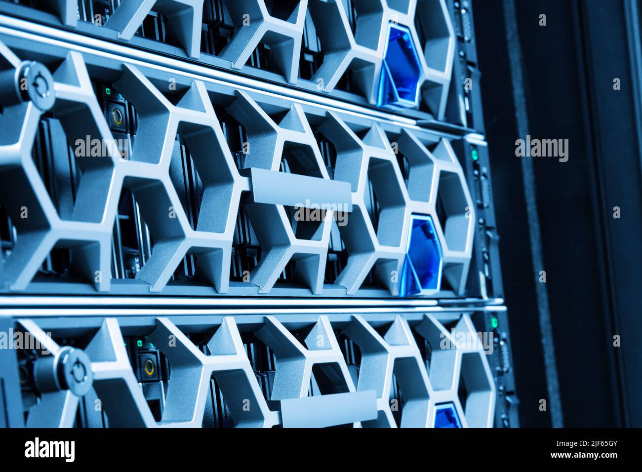 Closeup Of Modern Hard Drives In Illuminated Blue Datacenter Stock Photo