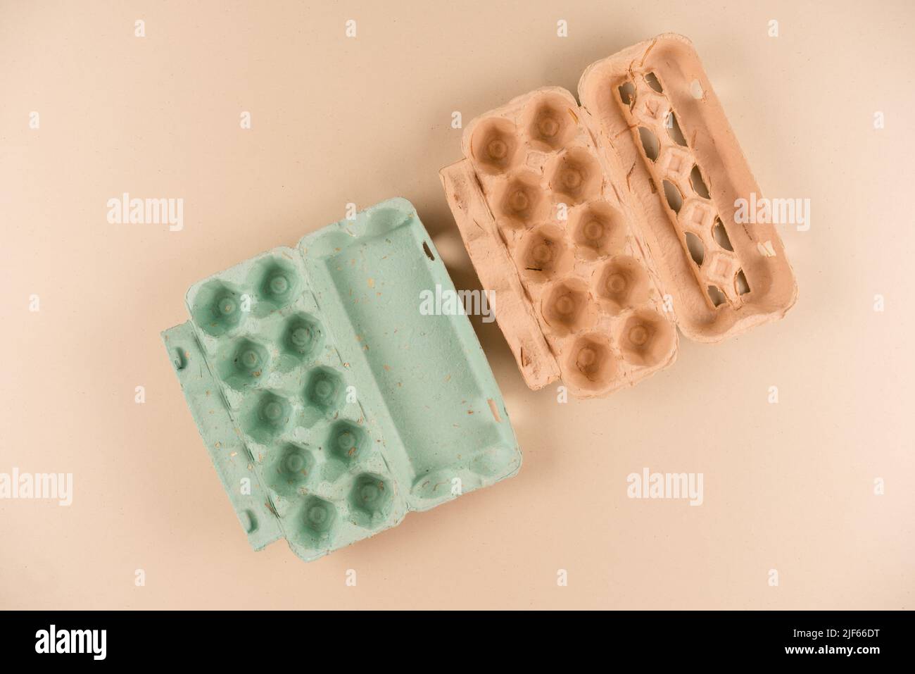 Pulp egg cartons made with pulp and natural straw over light brown