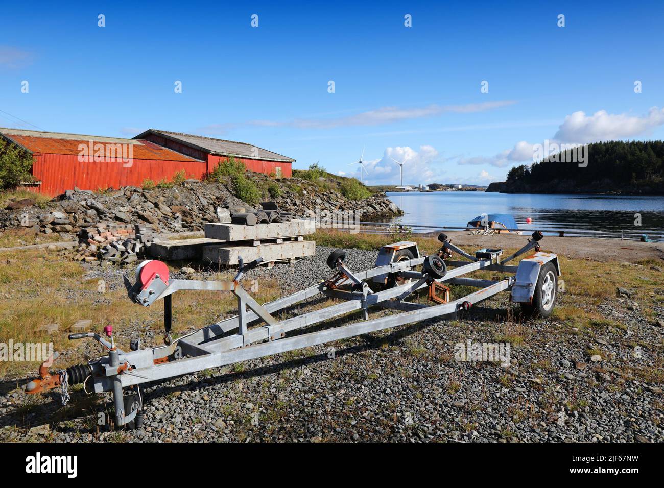 Norway coast in summer. Boat trailer in fishing harbor morning at Karmoy island. Stock Photo