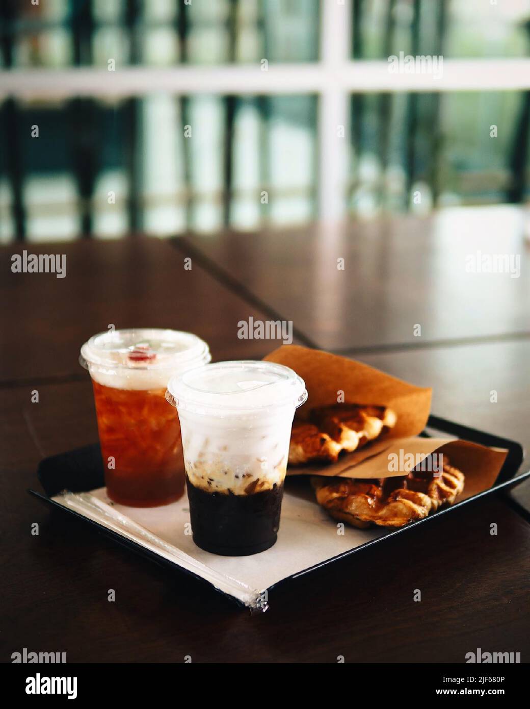 Ice coffee, americano coffee with orange in cafe. Stock Photo
