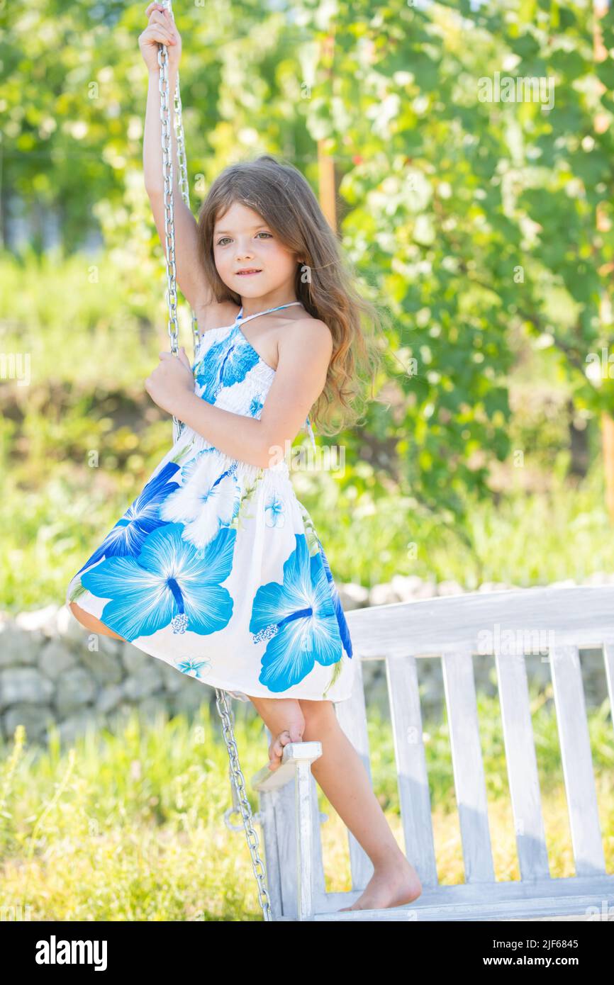 Foto de Beautiful little girl child in fashionable summer clothes