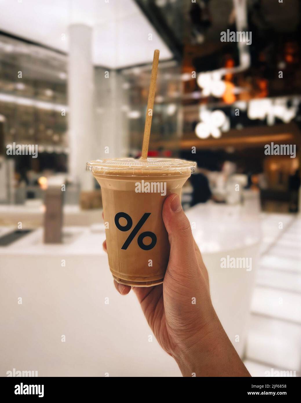 Latte coffee paper cup against river background in front of Arabica ...