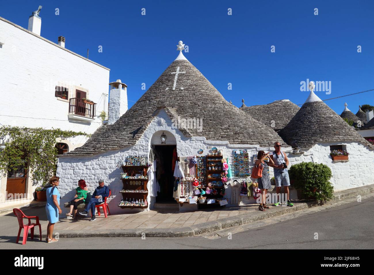ALBEROBELLO, ITALY - MAY 29, 2017: People visit a souvenir shop in Alberobello, Italy. Alberobello and its trulli houses are a UNESCO World Heritage S Stock Photo