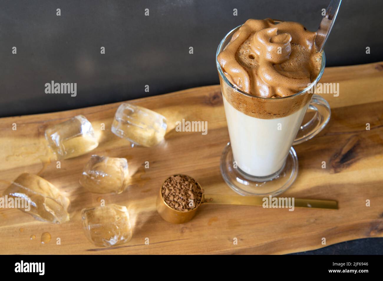 Iced coffee in tall glass. One sweet cold latte with whipped cream, with  chemex coffee maker on dark brown background copy space Stock Photo - Alamy