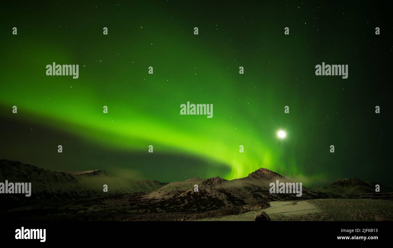 A mountain range with the Northern lights (Auroras) against a starry ...