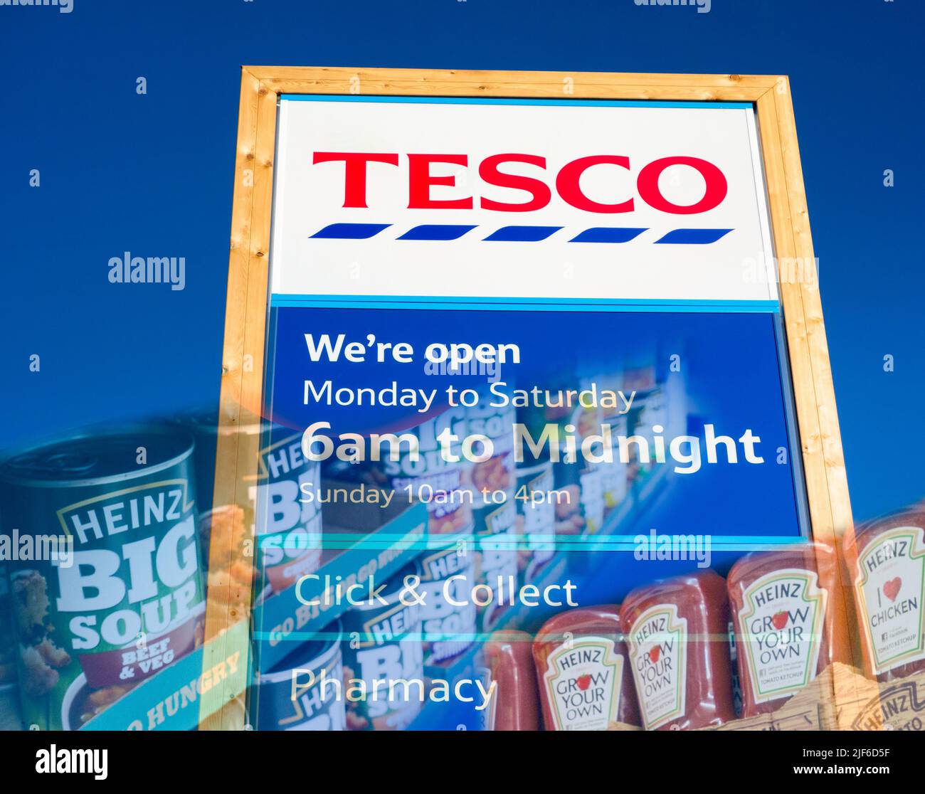 Sign outside Tesco supermarket with Heinz products overlayed. UK Stock Photo