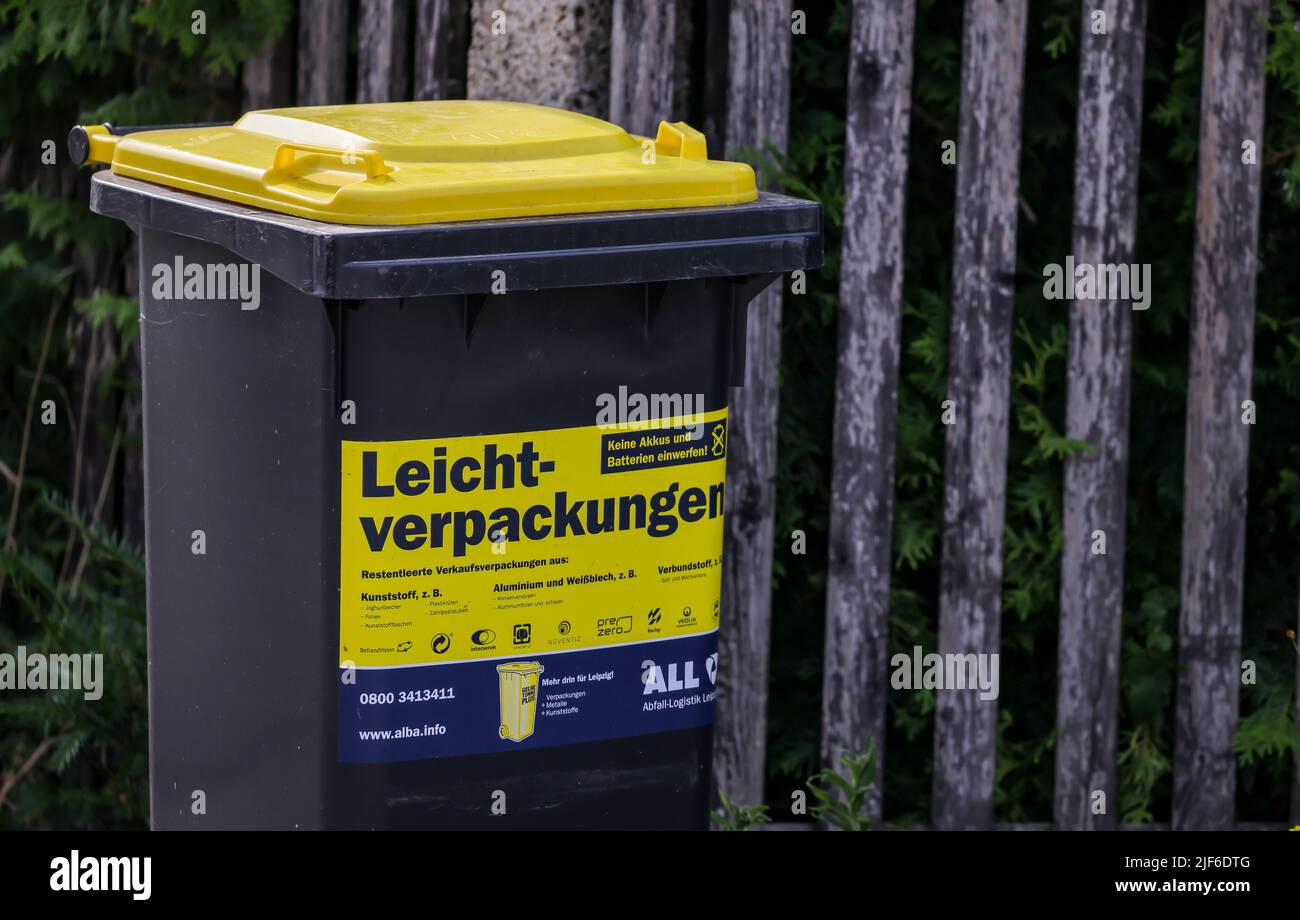 Leipzig, Germany. 30th June, 2022. A so-called yellow garbage can for light  plastic waste such as packaging stands on a small street in a housing  estate on an emptying day. The Institute