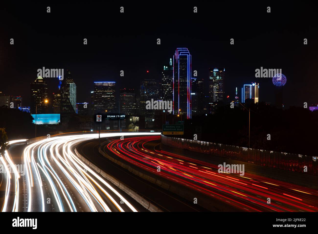 A high angle of the cityscape of Dallas, Texas illuminated by traffic