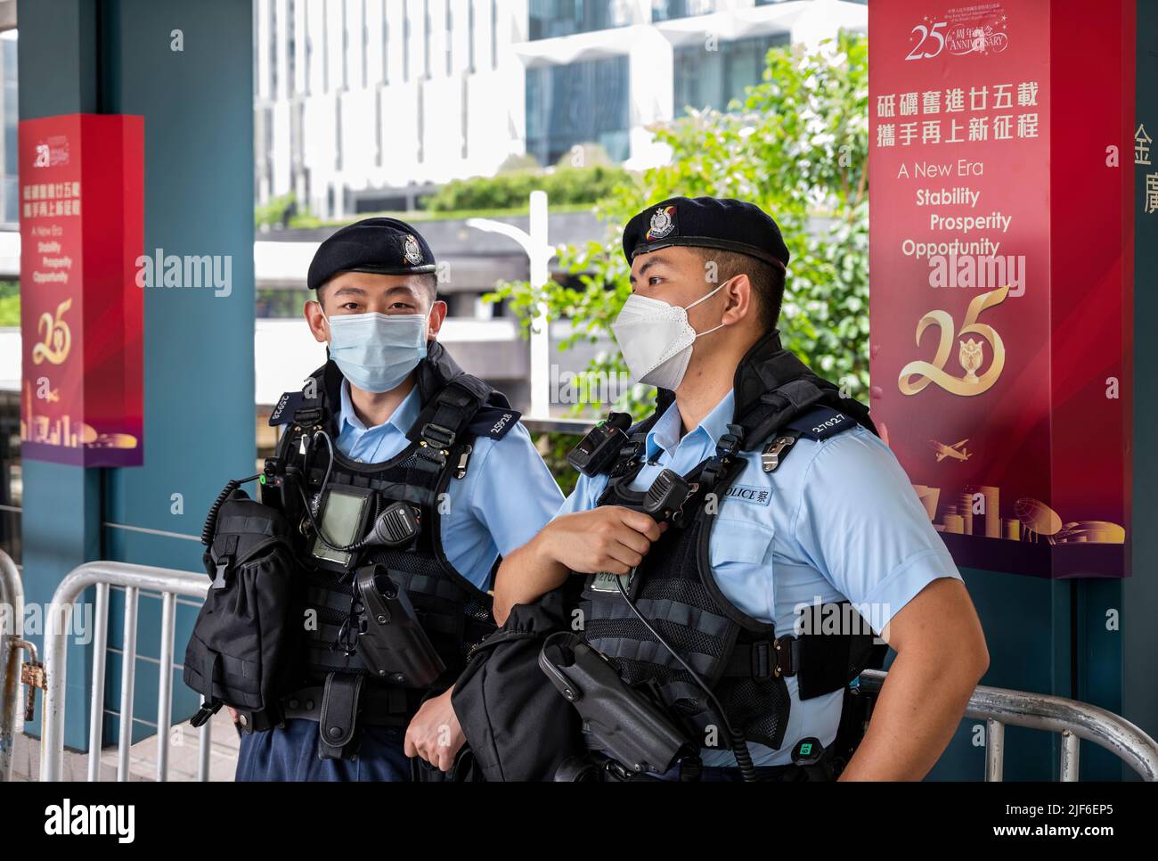Police officers stand guard next to a sign commemorating the July 1st