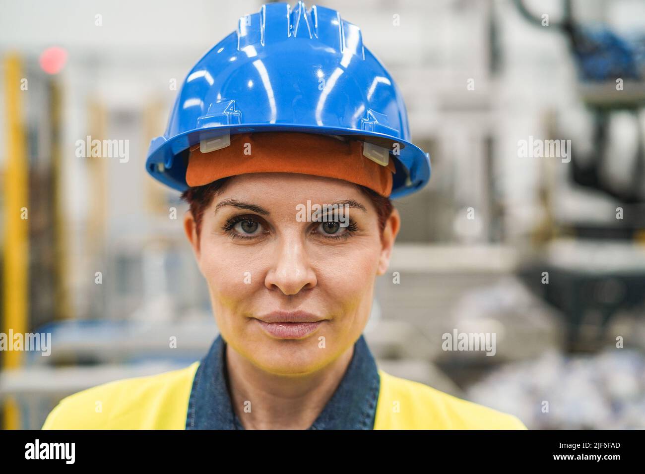 Senior engineer woman working inside robotic factory - Focus on face Stock Photo