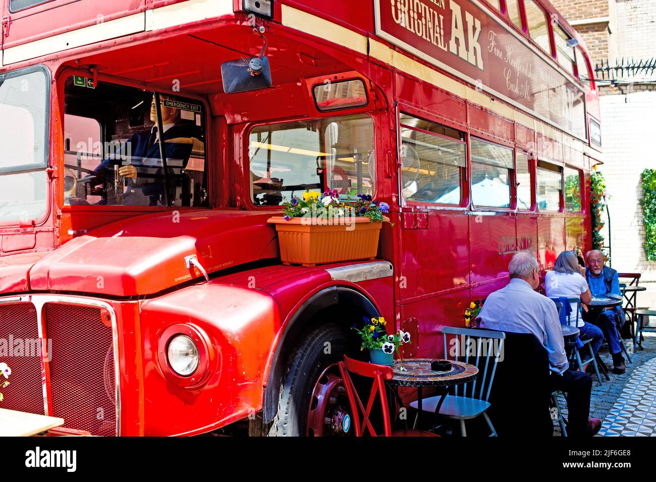 Routemaster Bus in beer garden of the Old Bank Pub, Fleet Street, London, England Stock Photo