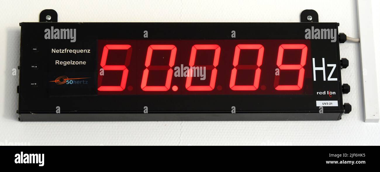 22 June 2022, Saxony-Anhalt, Bad Lauchstädt: In the office building of the Bad Lauchstädt substation, the current grid frequency is displayed, which changes within seconds depending on demand and supply. The substation is one of over 70 electricity hubs operated by the transmission system operator 50Hertz in eastern Germany and needs to be expanded in the course of the energy transition. Two so-called STATCOMs. are being built here to collect electricity from renewable energies, transform it to a higher voltage level and transport it to other regions via extra-high voltage lines. The high-te Stock Photo