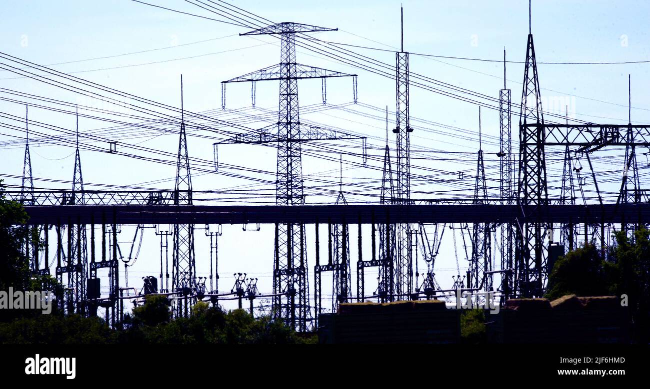 22 June 2022, Saxony-Anhalt, Bad Lauchstädt: Along a long-distance road, the facilities of the Bad Lauchstädt substation can be seen standing out against the blue sky. The substation is one of over 70 electricity hubs operated by the transmission system operator 50Hertz in eastern Germany and needs to be expanded in the course of the energy transition. Two so-called STATCOMs. are being built here to collect electricity from renewable energies, transform it to a higher voltage level and transport it to other regions via extra-high voltage lines. The high-tech facilities are intended to keep the Stock Photo