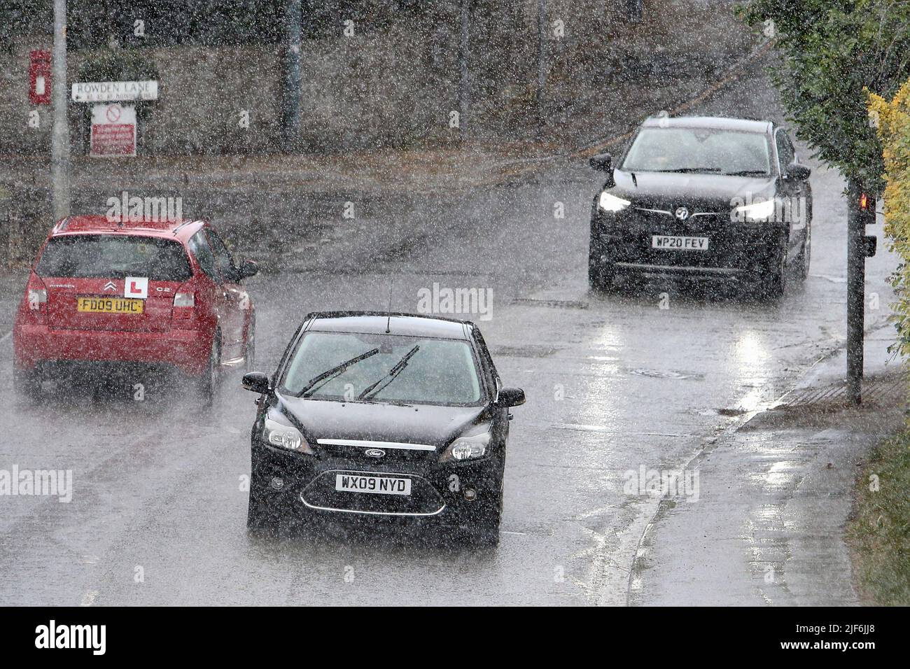 Chippenham, UK, 30th June, 2022. Car drivers are pictured braving heavy rain in Chippenham as heavy rain showers make their way across Southern England. Credit: Lynchpics/Alamy Live News Stock Photo
