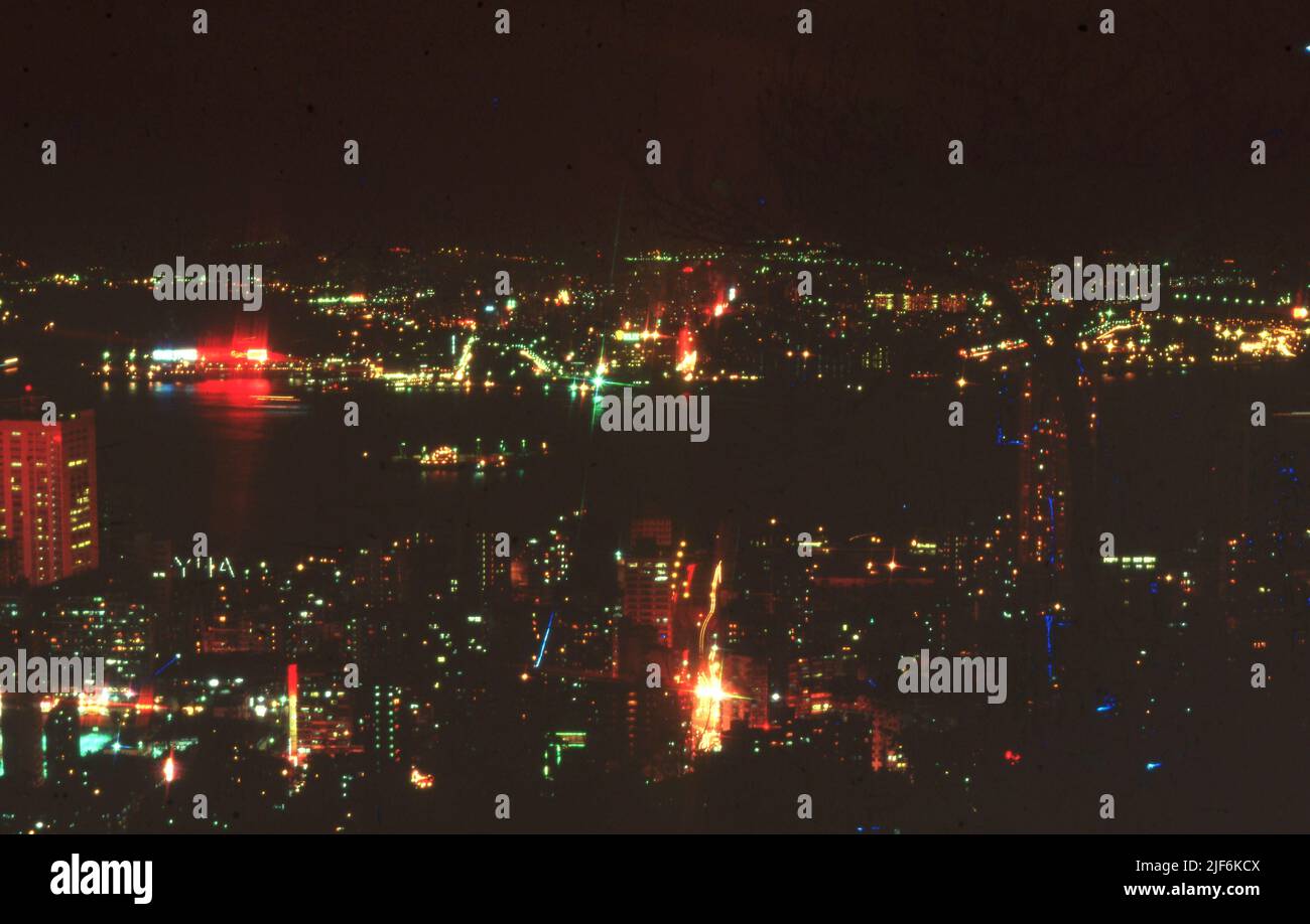 Kowloon at Night from Hong Kong Island 1979, on the left is Ocean Terminal with Wanchai in the foreground   Picture by Tony Henshaw Archive Stock Photo