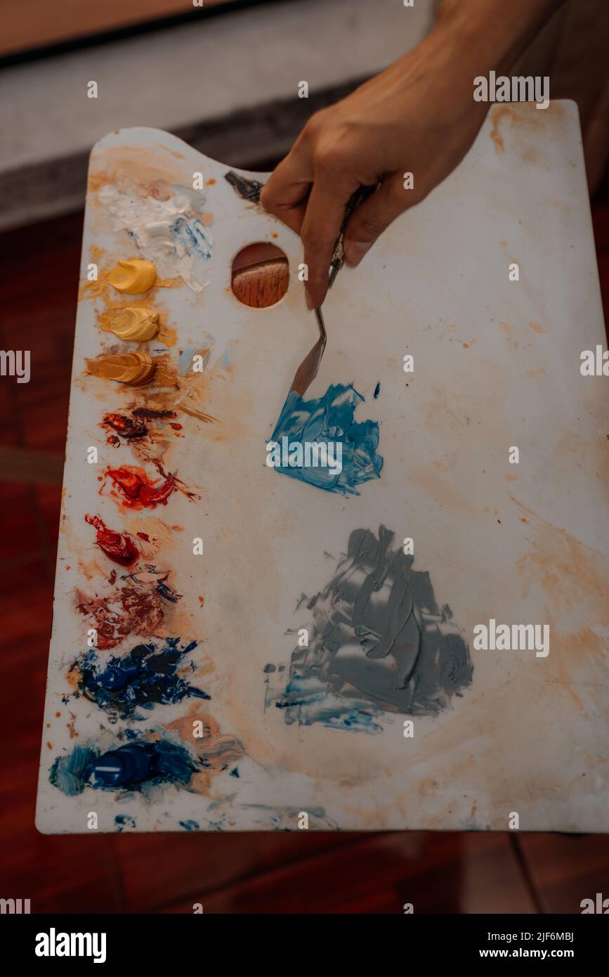 From above of crop anonymous person preparing color paint palette Stock Photo