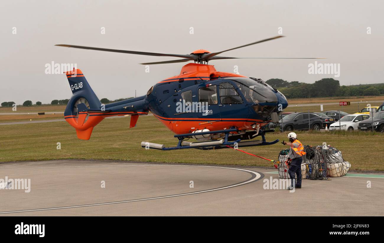 Cornwall, England, UK.2022. Airlift helicopter lifting off with cargo