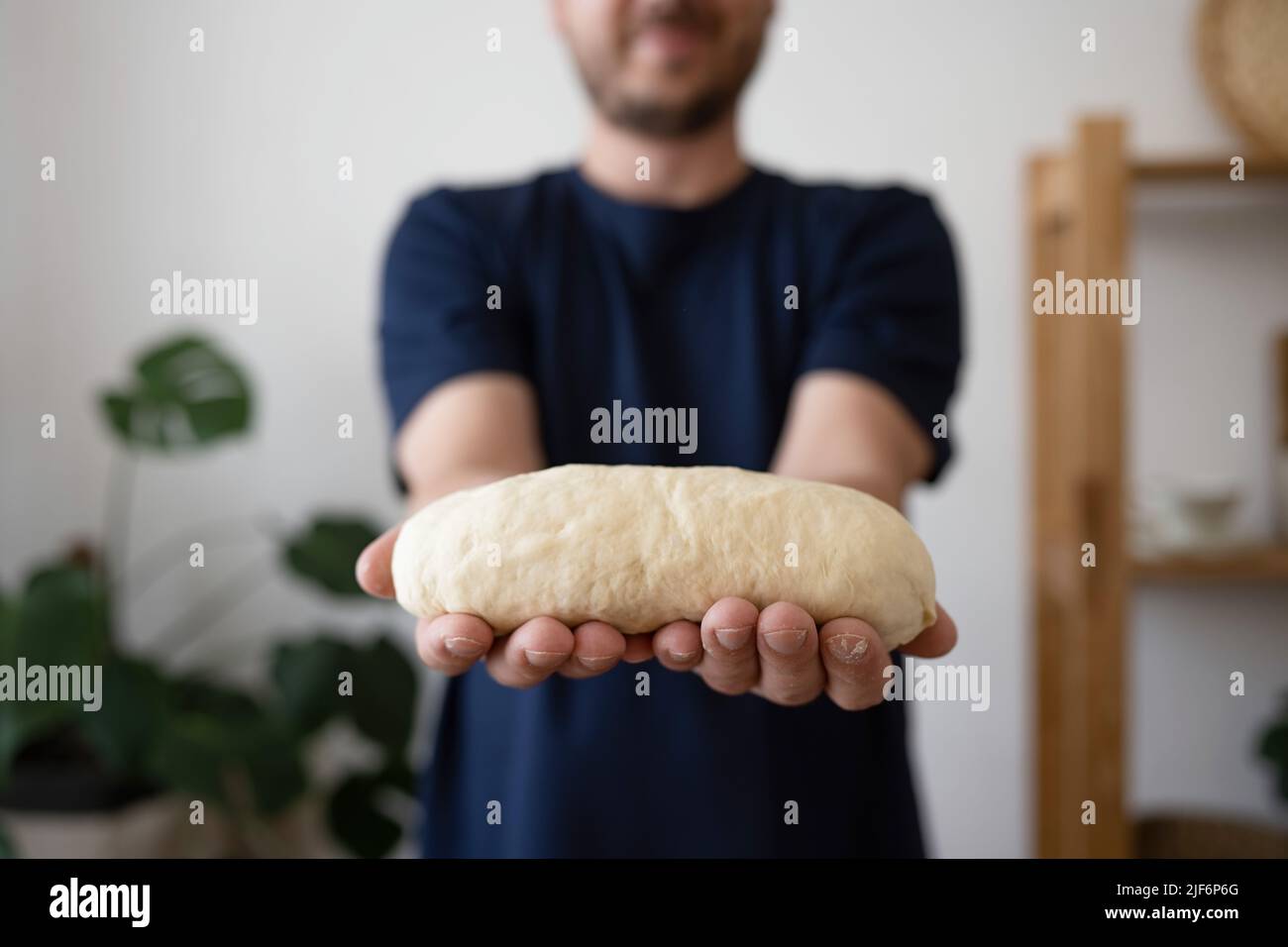 Midsection of man holding a finished clean dough at home Stock Photo ...
