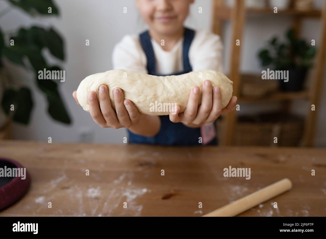 Midsection of girl holding a finished clean dough at home Stock Photo ...