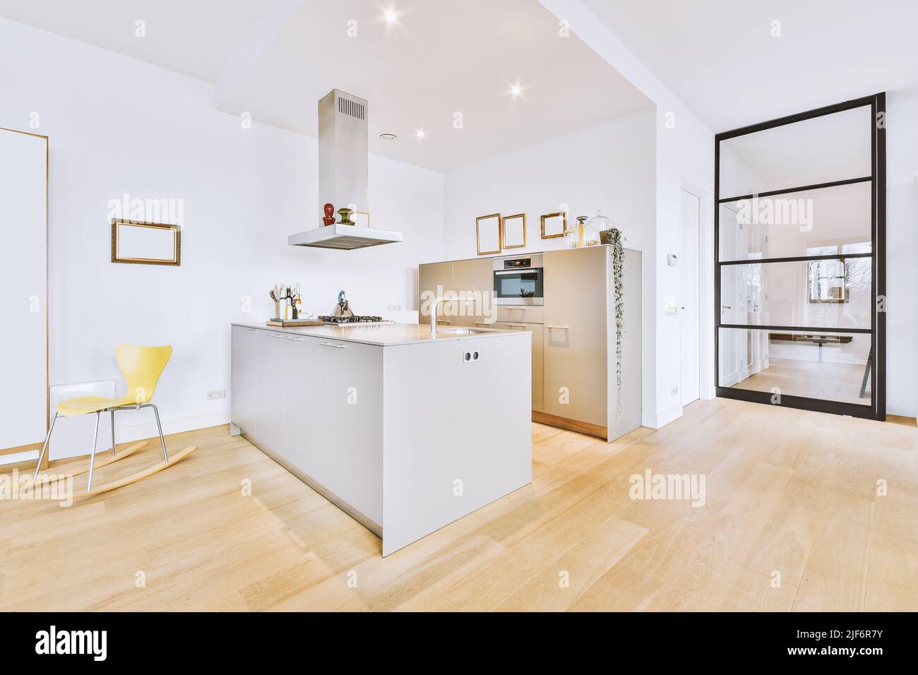 Interior of contemporary kitchen with gray counters and appliances in ...