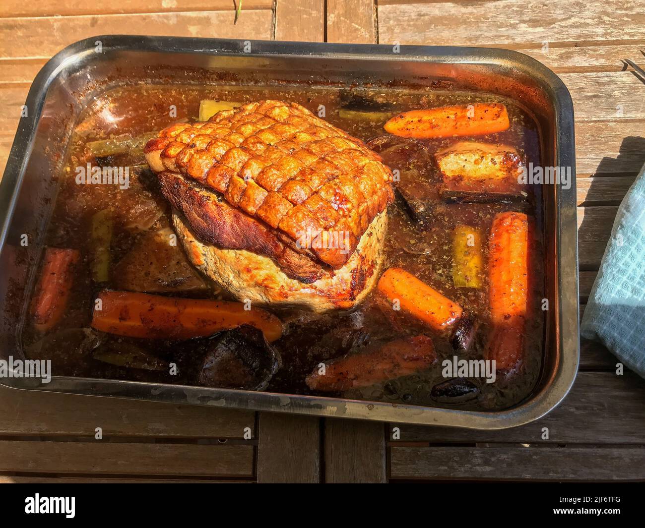 Crispy Roast Pork With Vegetables In The Roasting Tin Stock Photo Alamy