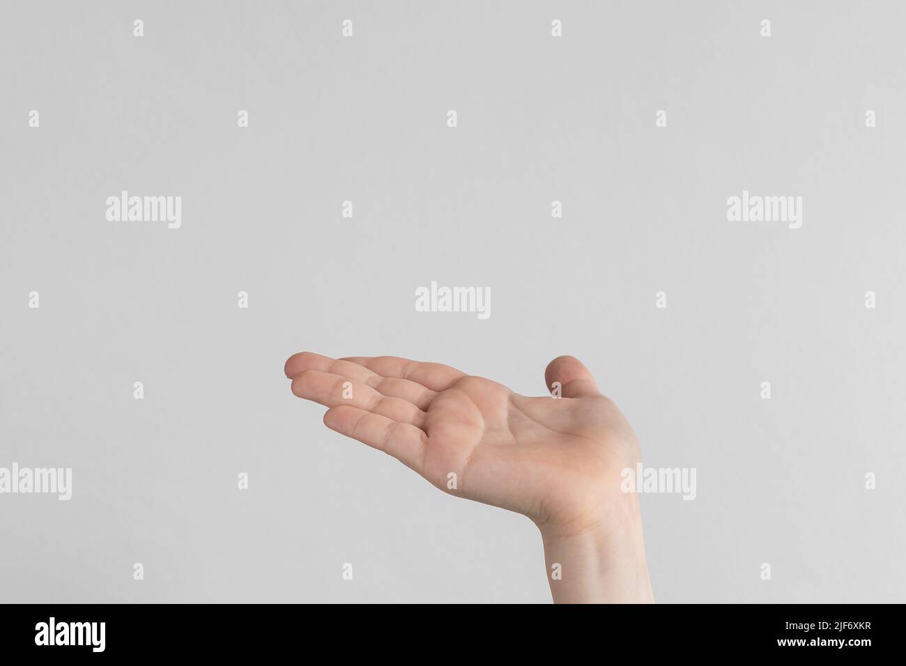 child hand palm up. side view Isolated on a white anf gray background ...