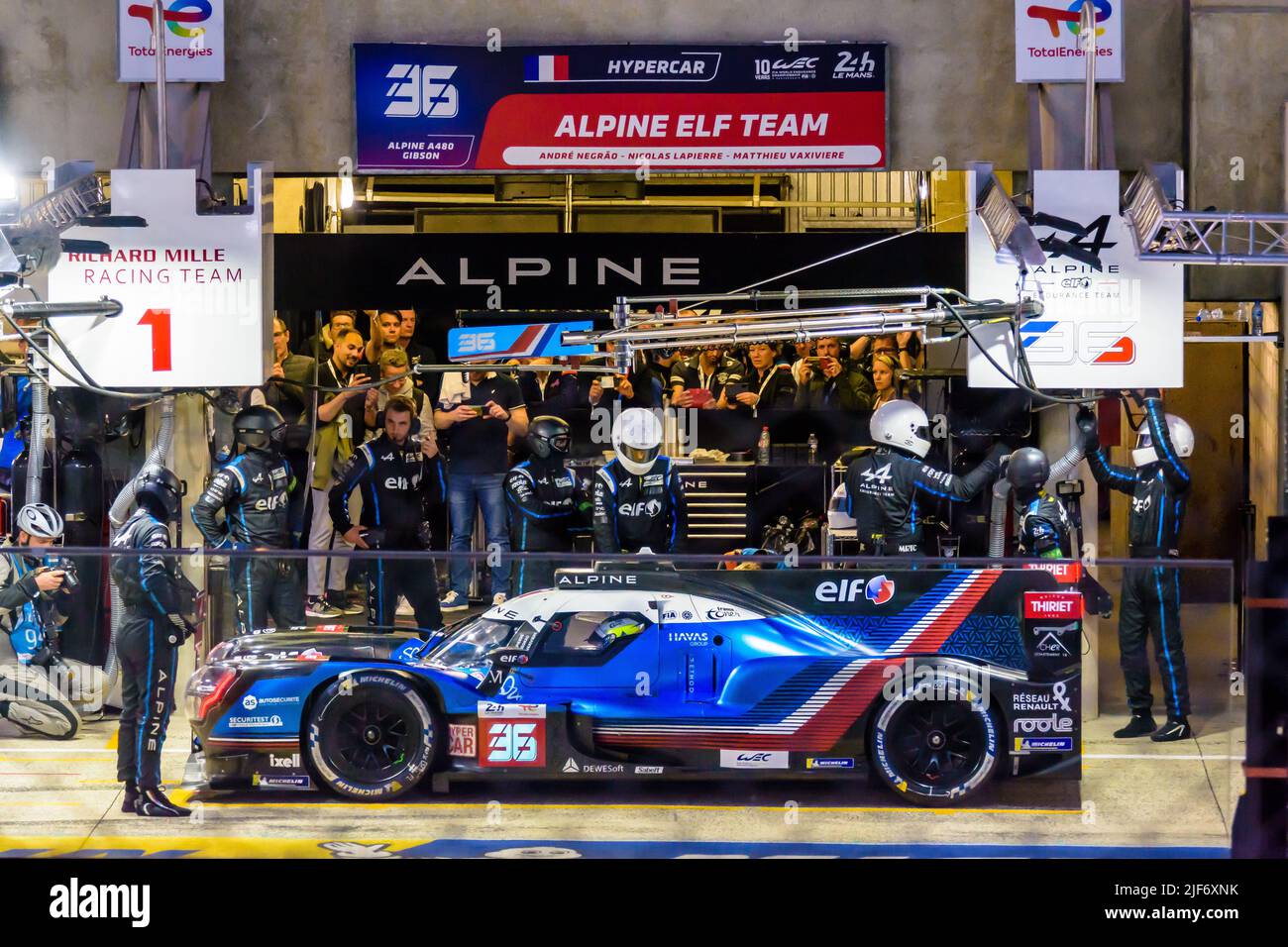 The Alpine A480 Hypercar race car number 36 performs a pit stop at night during the 24 hours of Le Mans. Stock Photo