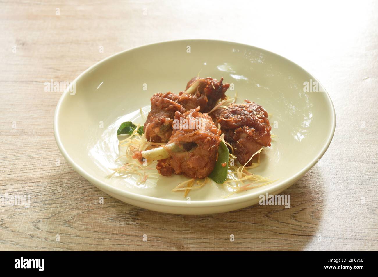 spicy fried chicken with chili and slice lemon grass on dish Stock