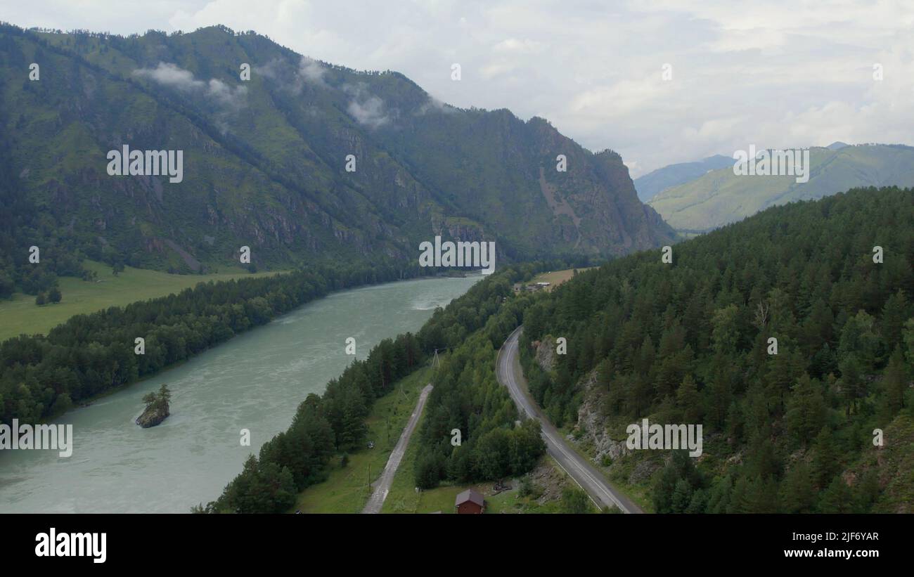 Katun river and road in mountains at during daytime, Altai, Siberia, Russia. Beautiful summer nature landscape at during daytime. Aerial view from a d Stock Photo