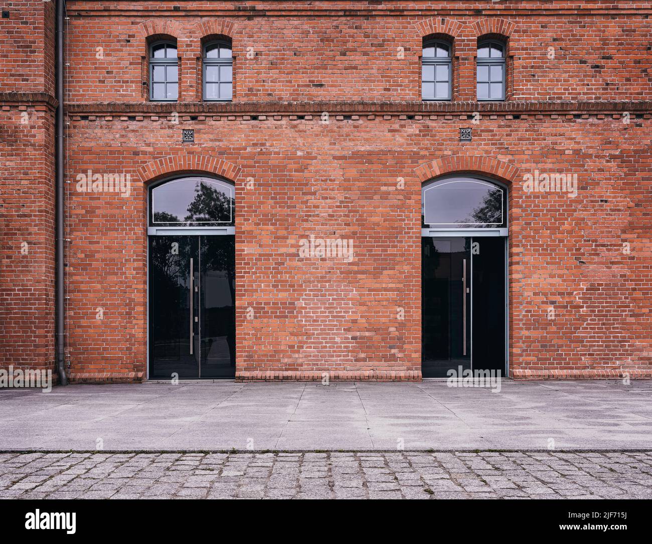 Industrial background, empty grunge urban street with warehouse brick wall Stock Photo