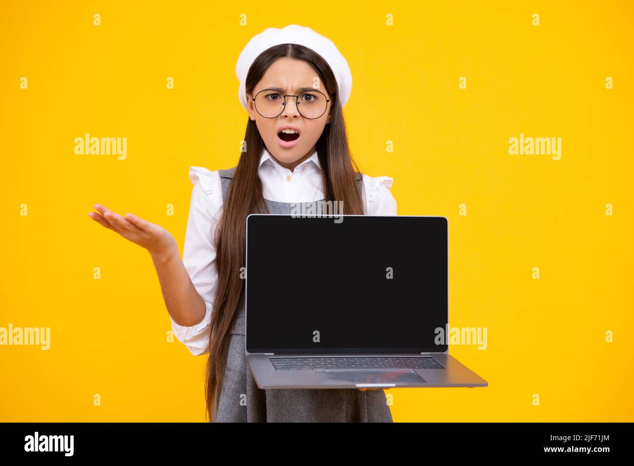 Student school girl with laptop on isolated studio background. Video online webinar, learn on laptop, elearning lesson, pc computer call. Surprised Stock Photo