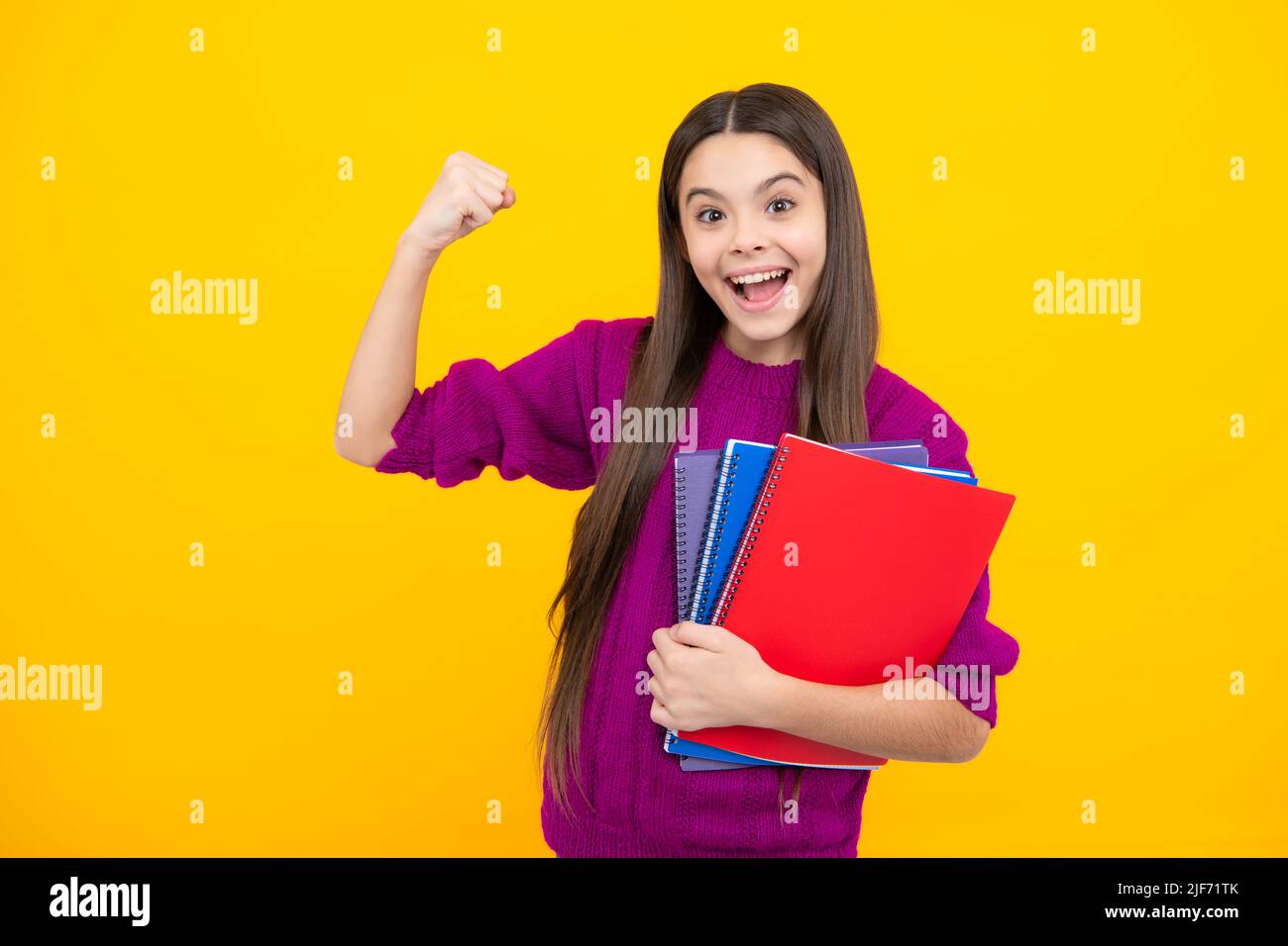 Excited face. Teenager school girl with books isolated studio background. Amazed expression, cheerful and glad. Stock Photo