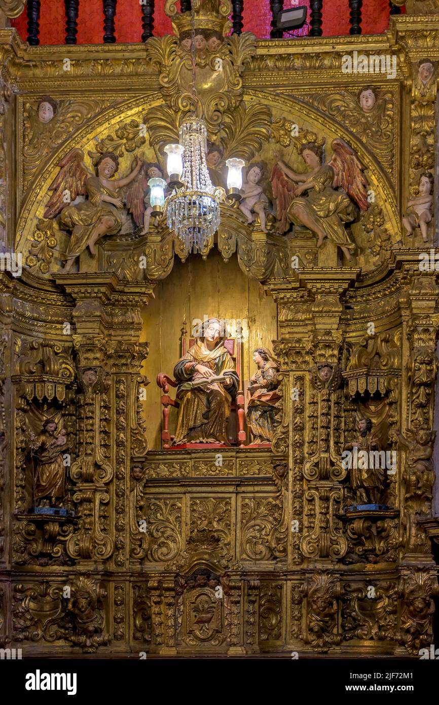 Interior of a baroque church decorated with images of saints and walls with gold leaf ornaments in the historic city of Ouro Preto, Minas Gerais Stock Photo