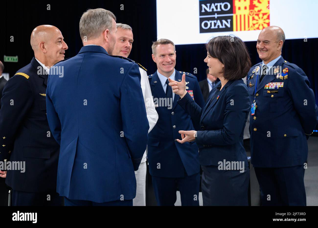 30 June 2022, Spain, Madrid: Annalena Baerbock (2nd from right, Bündnis 90/Die Grünen), Foreign Minister, talks with the highest-ranking Nato generals (l-r), General Philippe Lavigne, Supreme Allied Commander Transformation (Sact), General Tod D. Wolters, Supreme Allied Commander Europe (SACEUR), Admiral Rob Bauer, Chair of the Nato Military Committee, Lieutenant General Landrum, Deputy Chair of the Nato Military Committee, and Major General Lucas Muñoz Bronchales, SACT Representative in Europe. At the two-day summit, the heads of state and government of the 30 alliance countries took decision Stock Photo