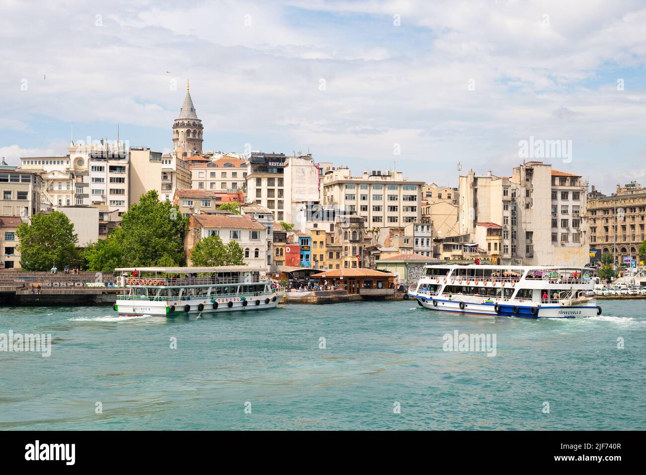 Karakoy, Beyoglu, Istanbul, Turkey - pictured: Galata tower and tourist boats on the Bosphorus Stock Photo