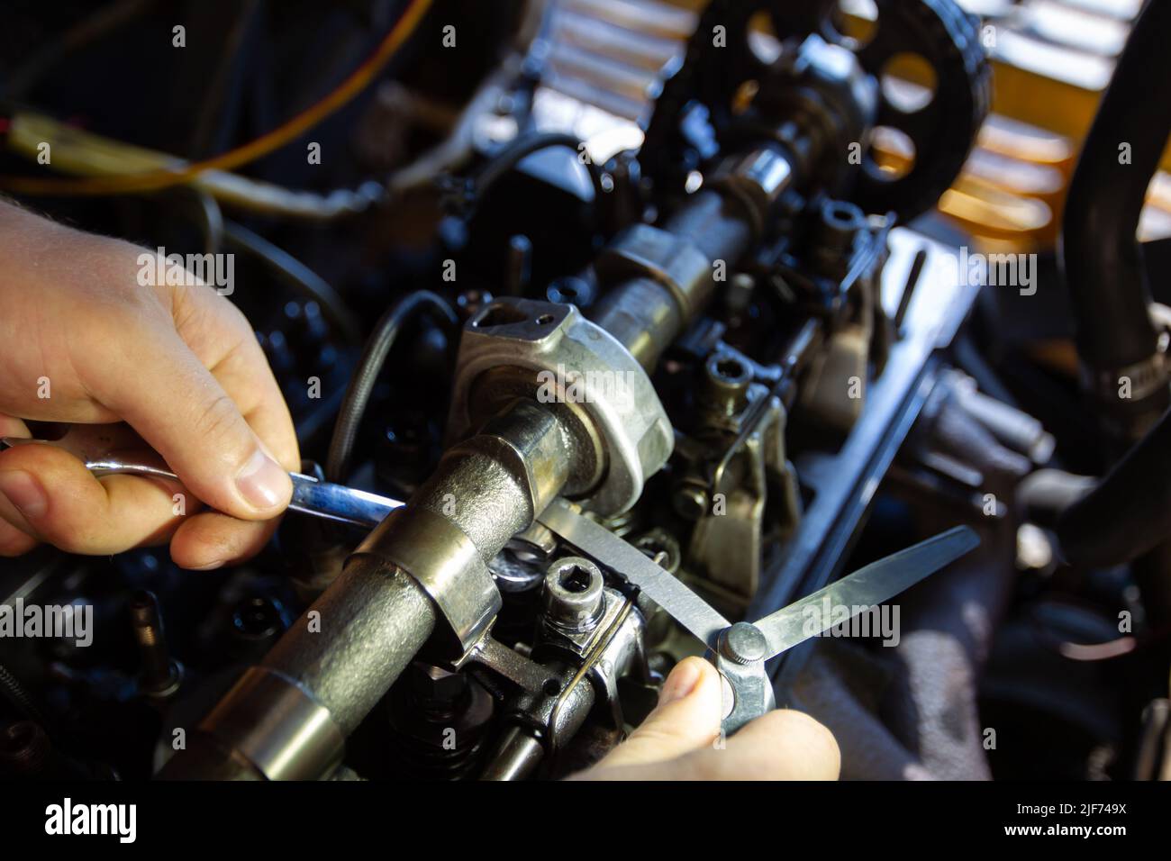 Mercedes diesel engine repair. Hands with a mechanic repairing Mercedes