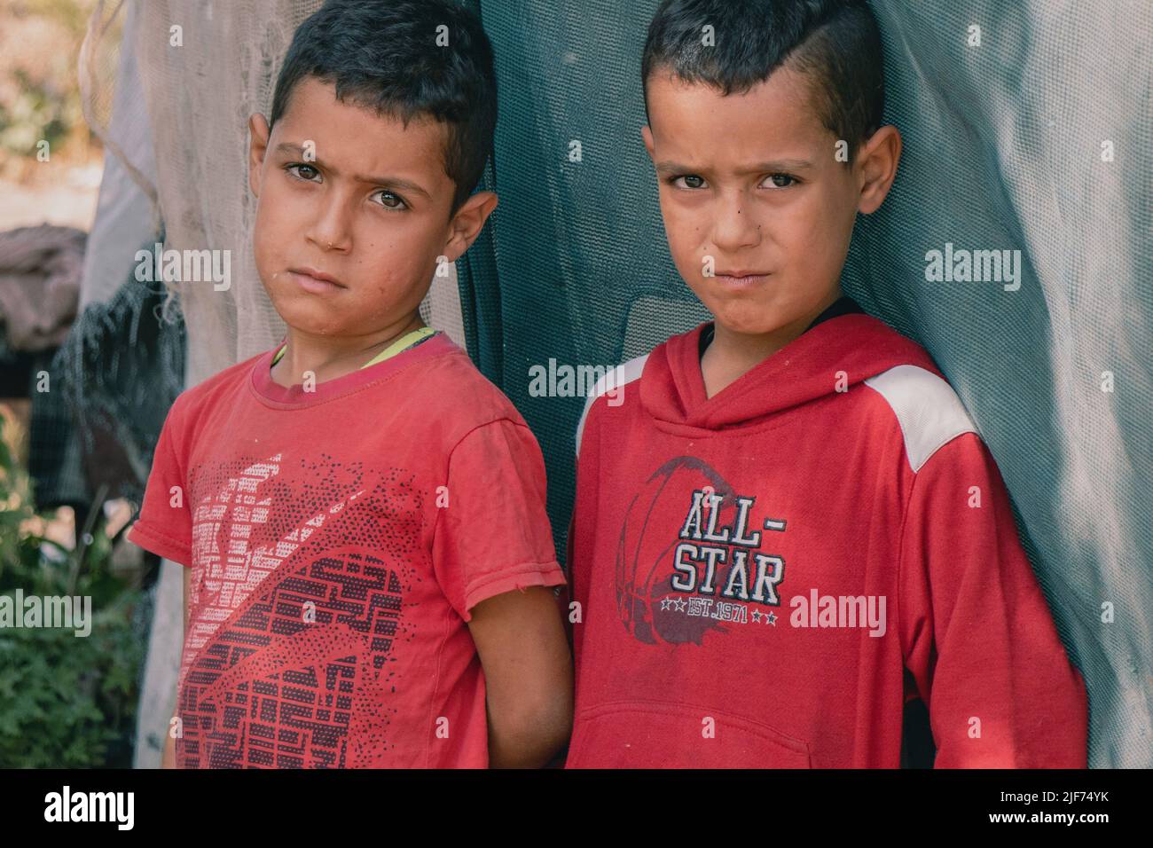 Syrian refugee children stand in hi-res stock photography
