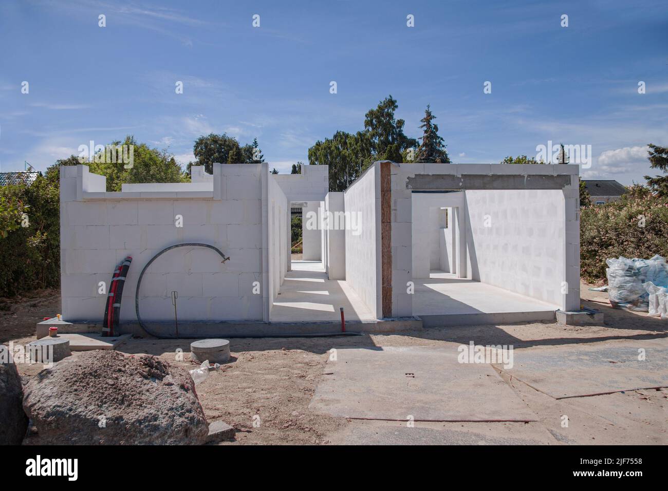 Construction site of a private family house. Unfinished house made of aerated concrete blocks. Only foundation and walls are showing. Real estate deve Stock Photo