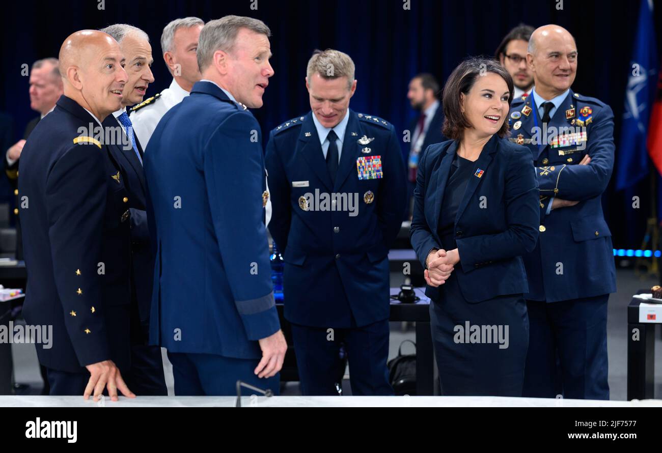 30 June 2022, Spain, Madrid: Annalena Baerbock (2nd from right, Bündnis 90/Die Grünen), Foreign Minister, talks with Mircea Geoana (2nd from left), Nato Deputy Secretary General, and the senior Nato generals (l-r), General Philippe Lavigne, Supreme Allied Commander Transformation (Sact), General Tod D. Wolters, Supreme Allied Commander Europe (SACEUR), Admiral Rob Bauer, Chair of the Nato Military Committee, Lieutenant General Landrum, Deputy Chair of the Nato Military Committee, and Major General Lucas Muñoz Bronchales, SACT Representative in Europe. At the two-day summit, the heads of state Stock Photo