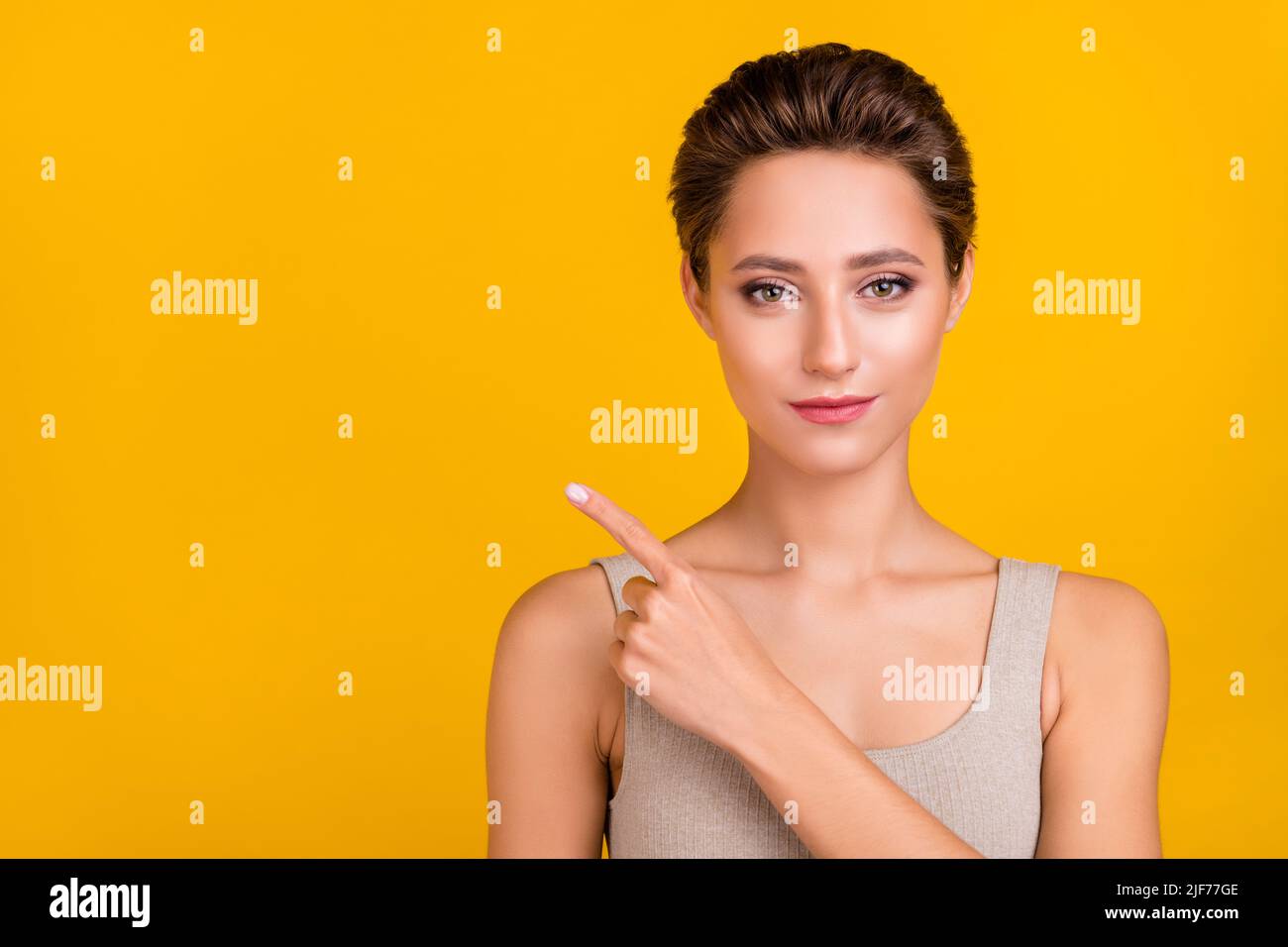 Portrait of attractive shine girl demonstrating copy empty blank space