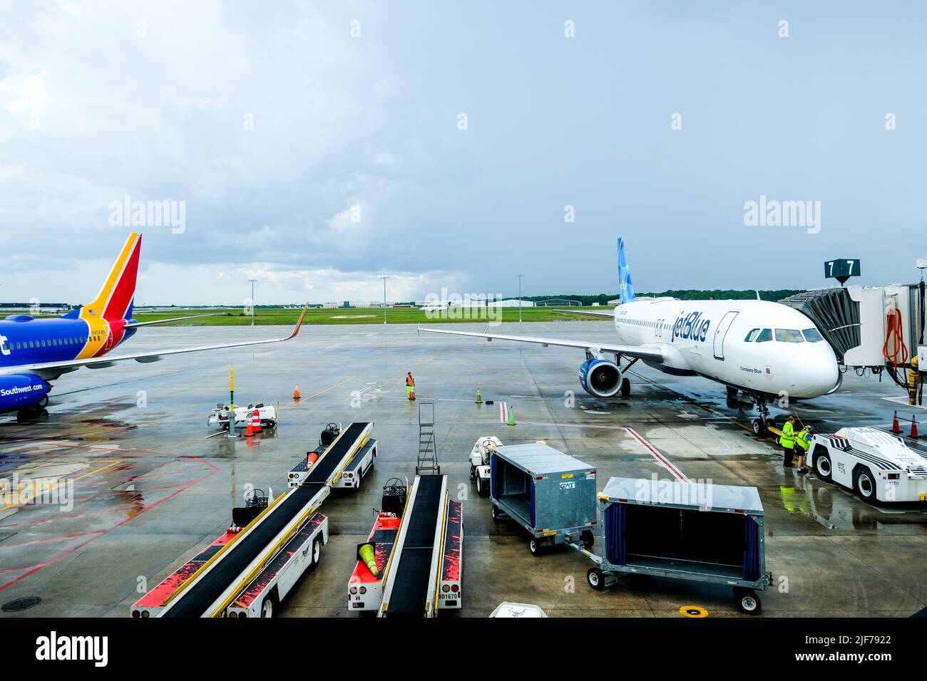 Flight cancellations stress weary travelers. Stock images of current flight delays around the USA. Disrupted travel plans. JetBlue plane on runway. Stock Photo