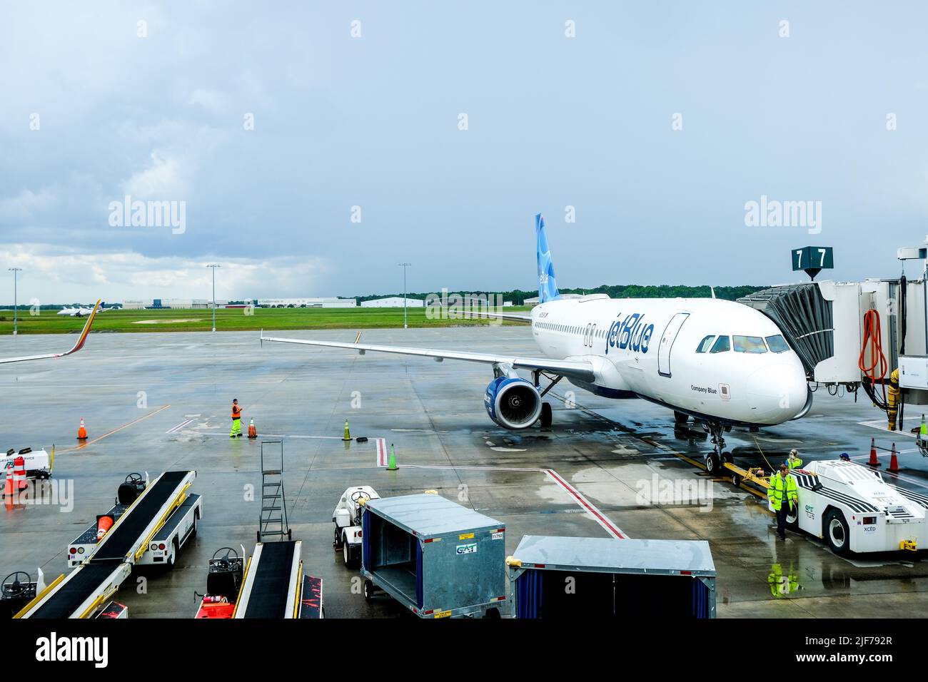 Flight cancellations stress weary travelers. Stock images of current flight delays around the USA. Disrupted travel plans. JetBlue plane on runway. Stock Photo
