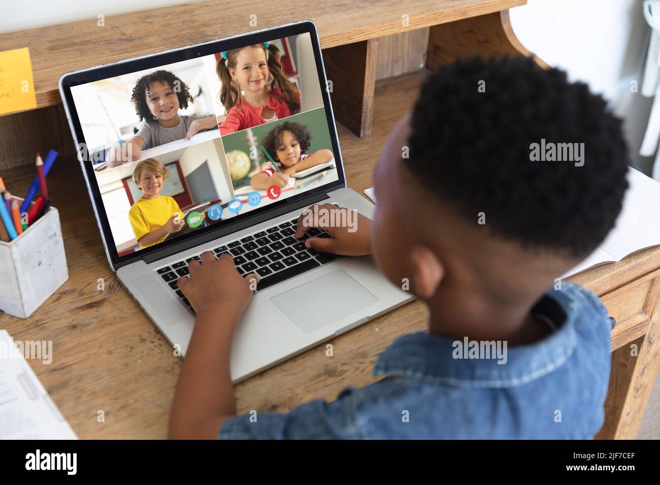 African american boy looking at laptop screen with multiracial students during online class Stock Photo