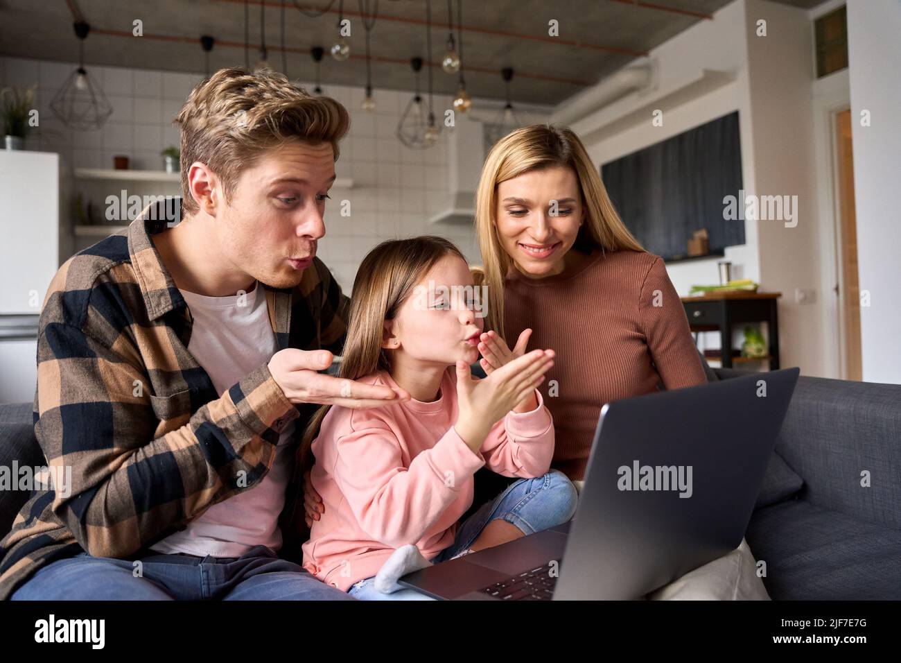 Funny family video calling using laptop computer at home. Stock Photo