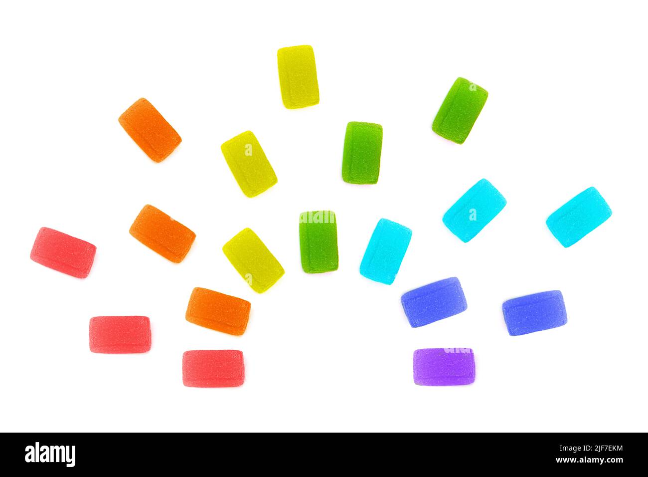 Three rows of fruit jelly cubes arranged into a rainbow shape isolated