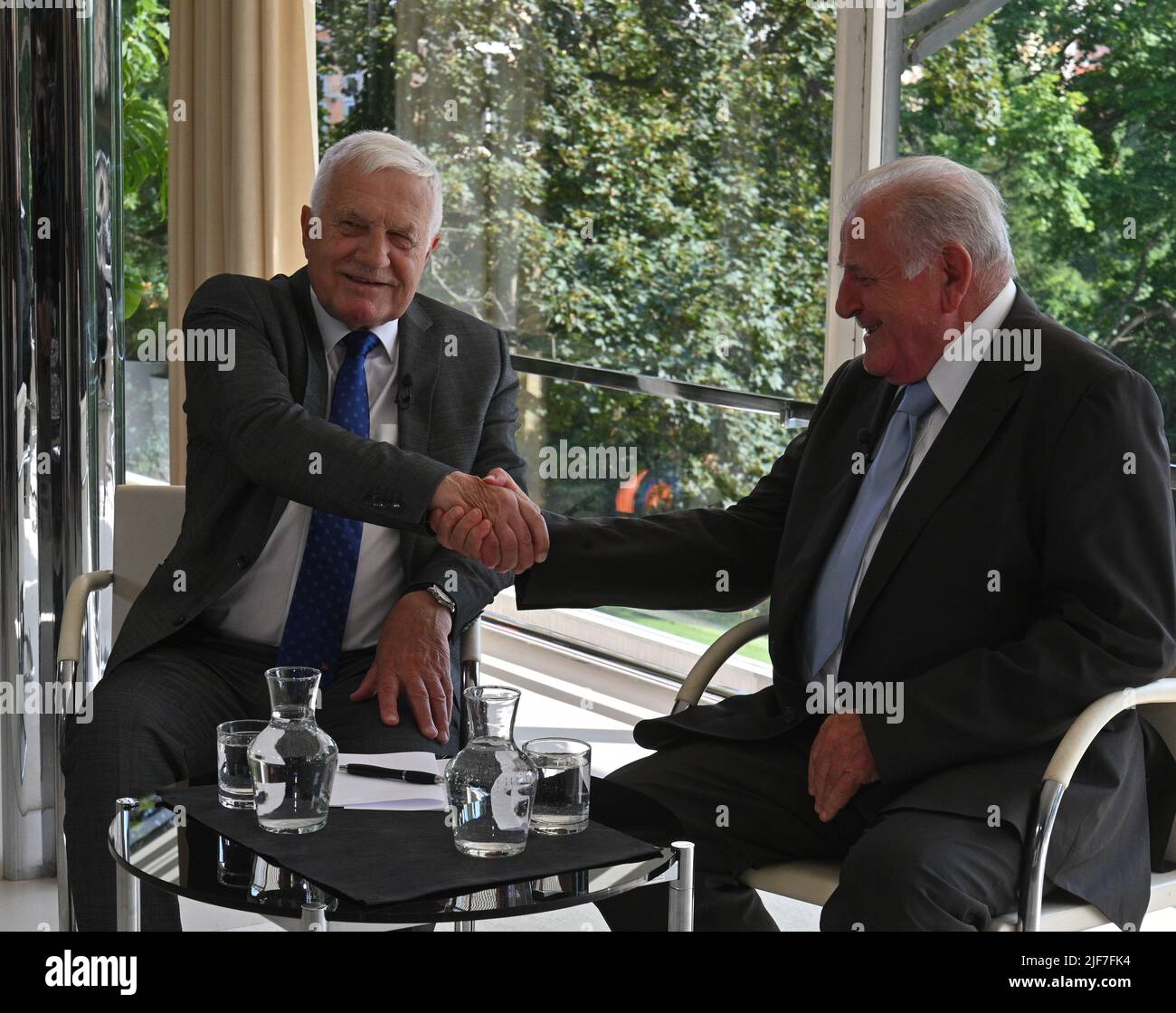 Brno, Czech Republic. 26th June, 2022. Former Czech Prime Minister Vaclav Klaus, left, and former Slovak Prime Minister Vladimir Meciar, right, handshake during their discussion at Tugendhat villa in Brno, Czech Republic, on June 30, 2022, where they negotiated about split of Czechoslovakia 30 years ago. The discussion is organized by public Czech Radio (CRo) and Slovak TV (RTVS). Credit: Igor Zehl/CTK Photo/Alamy Live News Stock Photo