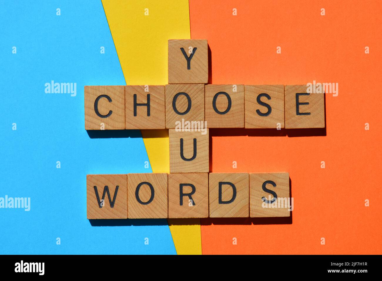 Choose Your Words, in wooden alphabet letters in crossword form isolated on colorful background Stock Photo