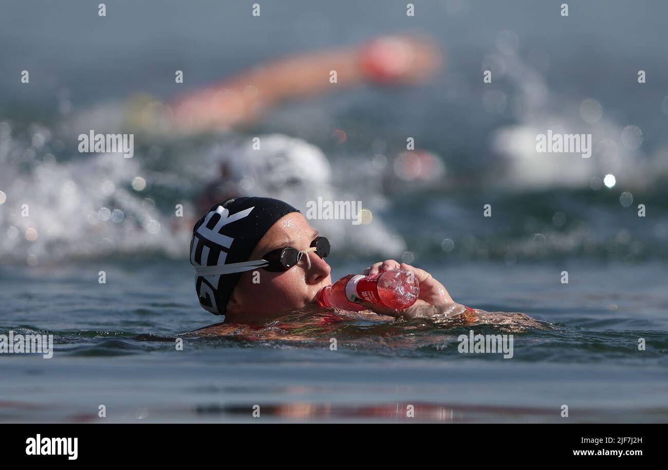 Budapest, Hungary. 30th June, 2022. Swimming, World Championship, open water, 25km women: Lea Boy from Germany fortifies herself during the race with a sip from a bottle. Credit: Ian MacNicol/dpa/Alamy Live News Stock Photo