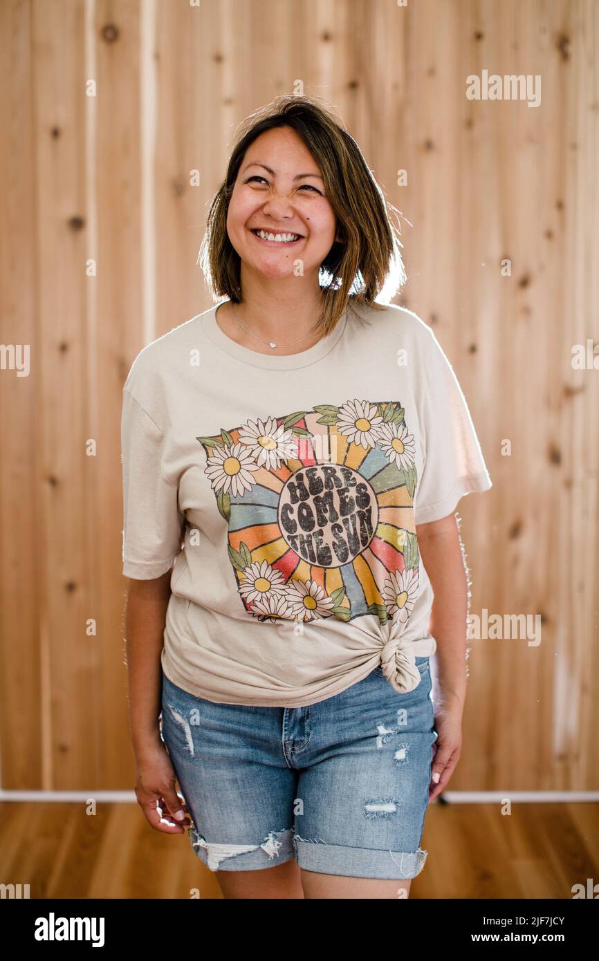 Chinese Woman Modeling Graphic Tee in Studio in San Diego Stock Photo